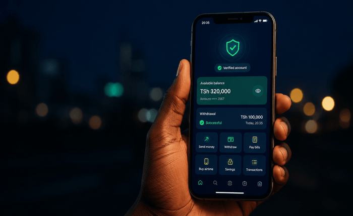 Smartphone glowing in hand at night representing mobile money verification for Paripesa Tanzania
